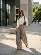 Beige wide leg pants worn by a model on the street