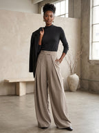 Beige wide leg pants worn by a model in the studio