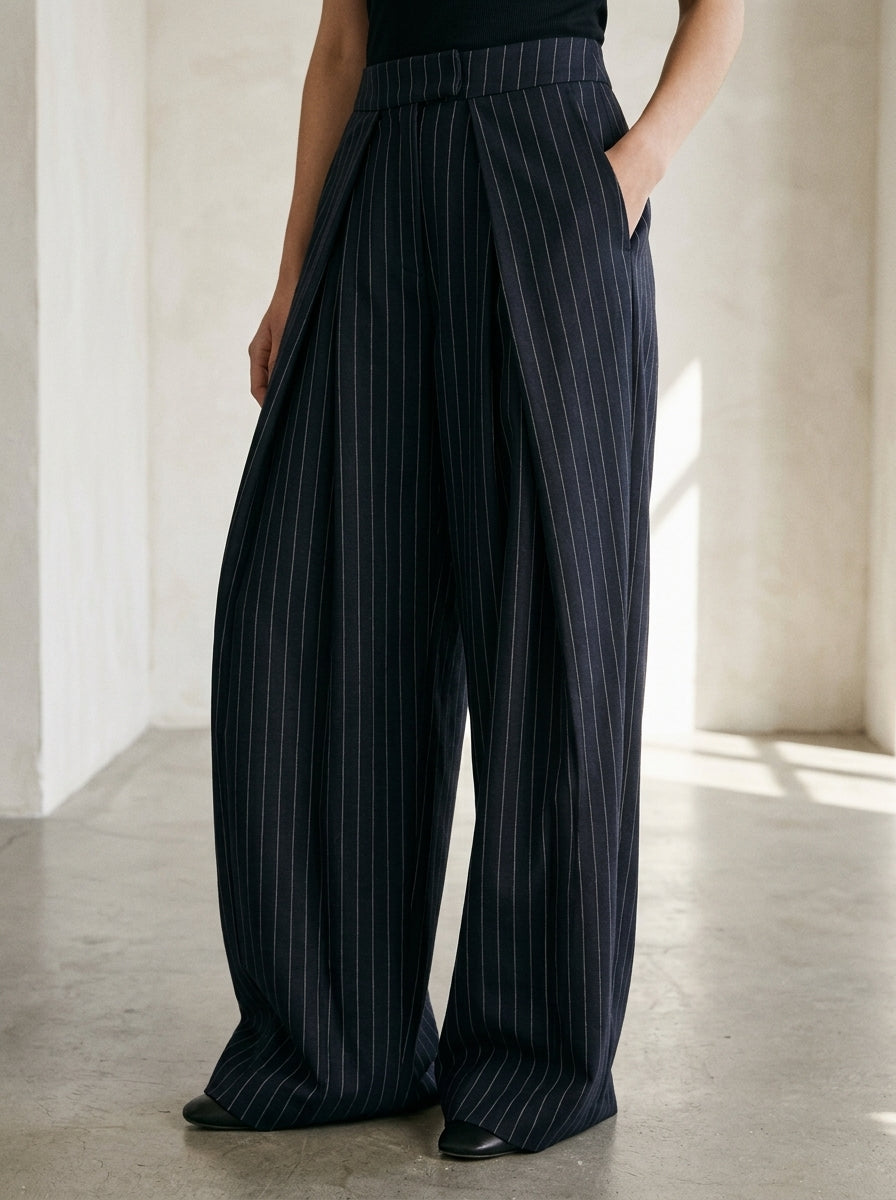 Navy pinstripe wide leg pants, close-up of the front pleats