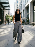 Grey wide leg pants worn by a model on the street